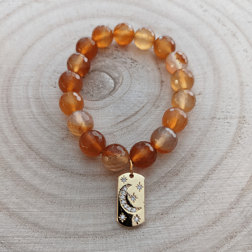 faceted_orange_carnelian_celestial_charm_184_wood_bg