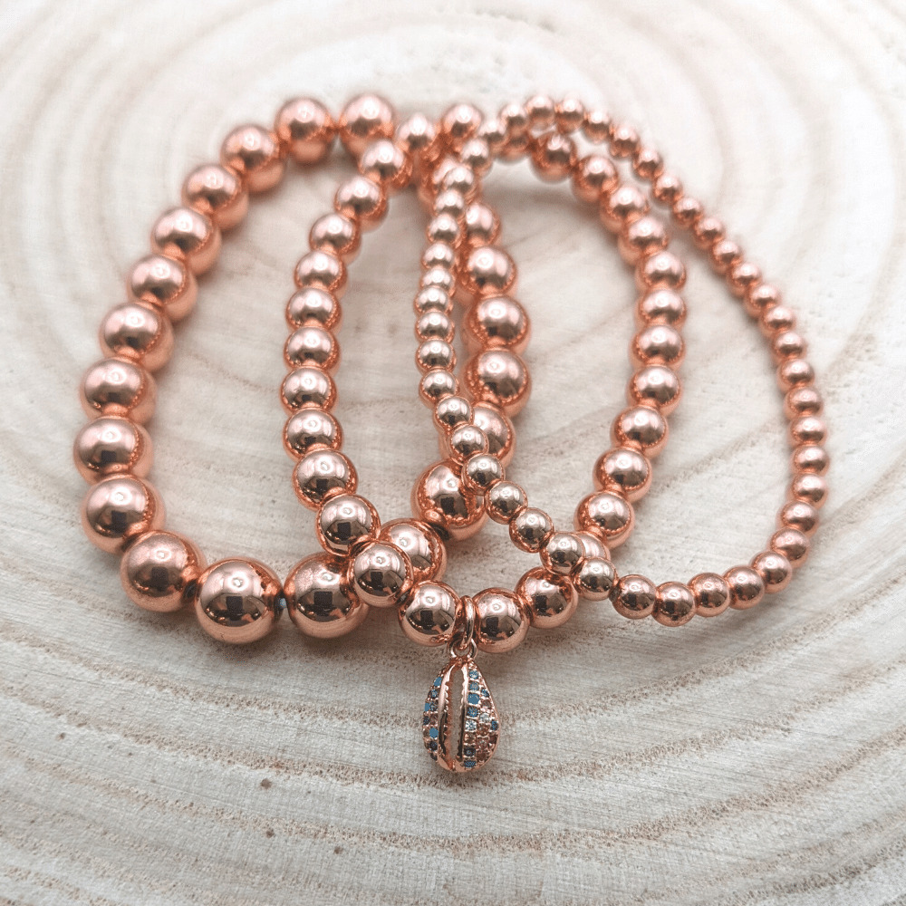 rose-gold_three_piece_bracelet_set_148_rg_wood_bg